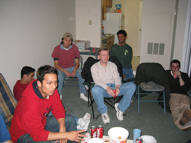 Small group sitting around, drinking soda and eating chicken