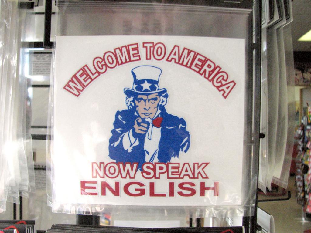 Image of a sign will Uncle Sam saying "Welcome to America, now speak English."