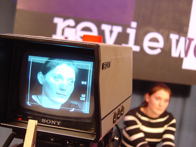 Television studio with camera focused on a presenter
