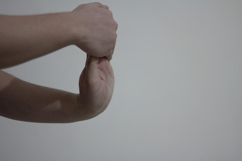Image of person stretching their wrists.