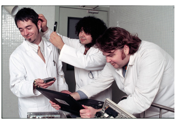 Three scientists working on an experiment.
