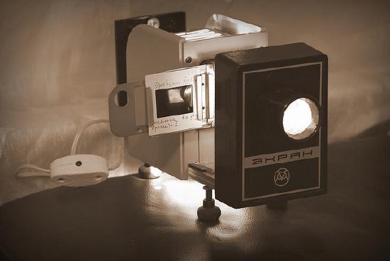 Old fashioned slide projector with a slide in it