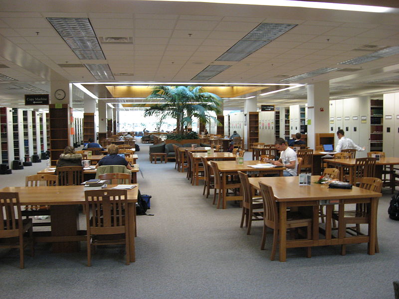A college library where students are studying at tables.