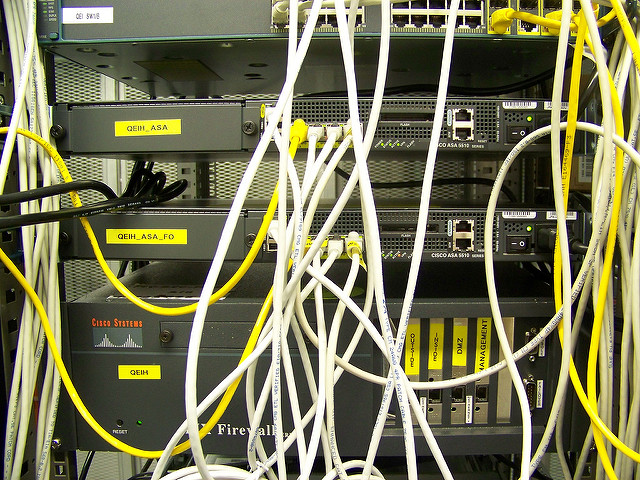 Many telephone cords and cables connecting many different machines.