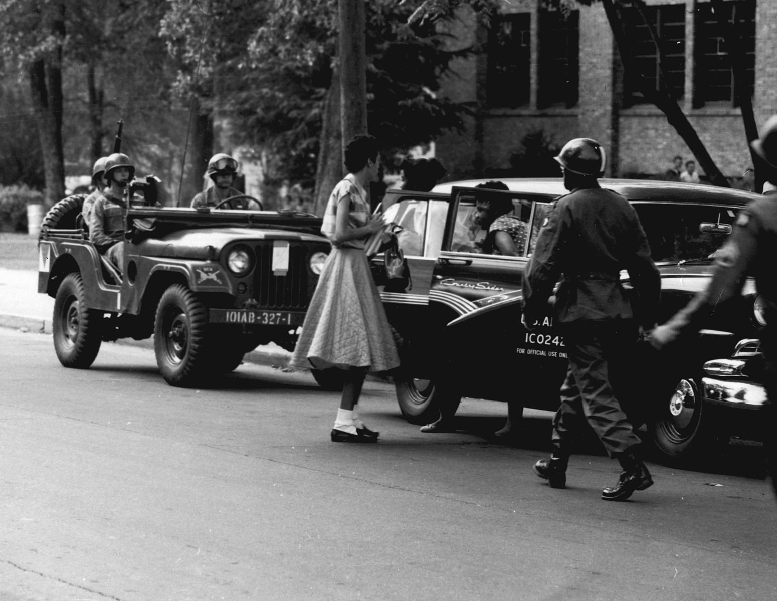 A student walking to the Little Rock school. The “Little Rock Nine” were the first to do this in Arkansas; their escorts, the 101st Airborne Division of the U.S. Army, provided protection to these students who so bravely took that first step.
