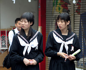 Two Japanese school girls in Sailor Moon dress