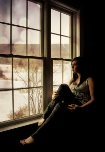 Woman sitting in front of window