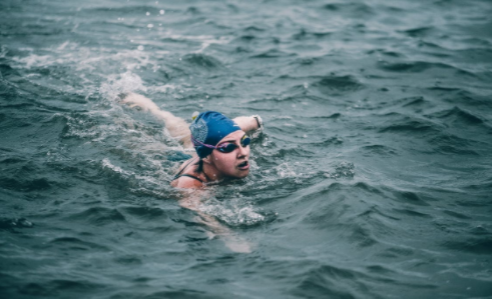 Person swimming in the ocean by Sergio Souza