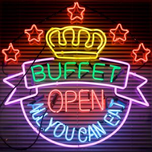 A neon sign advertises an all-you-can-eat buffet." title="A neon sign advertises an all-you-can-eat buffet.
