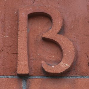 Close up image of the marking on the side of a building. It isn't clear if the marking is the number 13 or the letter B." title="Close up image of the marking on the side of a building. It isn't clear if the marking is the number 13 or the letter B.