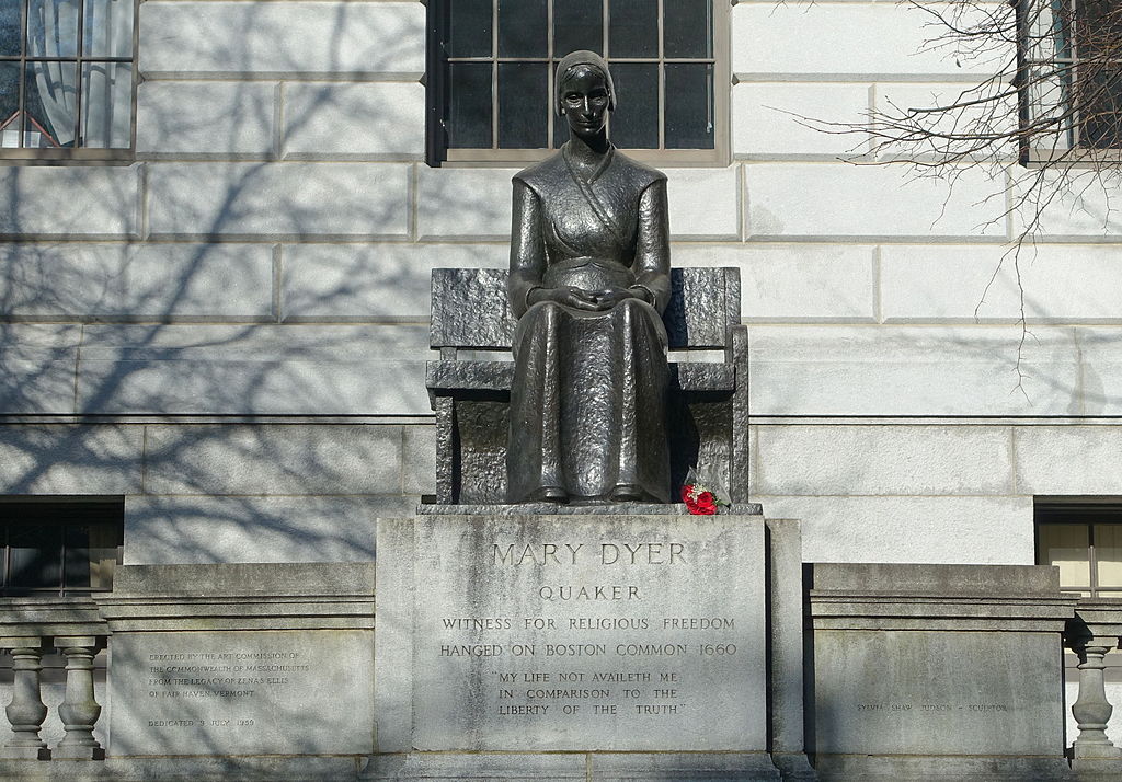 Brass statue of Mary Dyer, on a stone pedestal reading "Mary Dyer. Quaker. Witness for religious freedom. Hanged on Boston Common, 1660. 'My life not availeth me in comparison to the liberty of the truth.'"