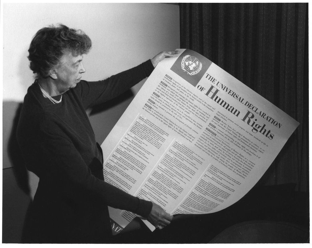 Eleanor Roosevelt holding a poster of the UN's Universal Declaration of Human Rights (written in English).
