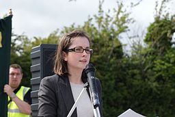 Speaker standing behind a microphone