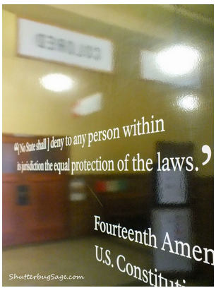 The quote "[No State shall] deny to any person within its jurisdiction the equal protection of its laws" from the 14th Amendment to the Constitution is printed on a sheet of glass at the Brown v. Board of Education historical site.