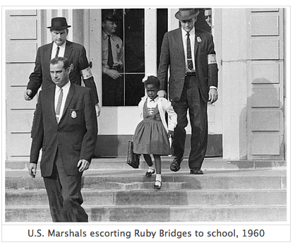 Three U.S. Marshals escort Ruby Bridges from her schoolhouse, all descending a set of steps. Two other men, one of whom appears to be a police officer, are standing inside the schoolhouse, visible from the front windows.