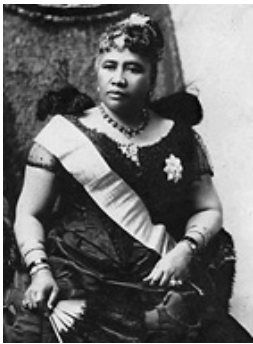 Formal studio photograph of Queen Liliuokalani, seated in a chair and wearing a dress with a white sash over one shoulder and a feather cloak, taken by James J. Williams around 1891.