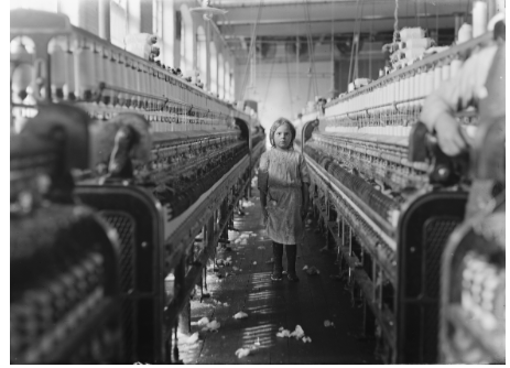Black-and-white photograph of a young girl working in Mollohan Mills, Newberry, South Carolina. Photograph taken in 1908 by Lewis W. Hine for the National Labor Committee.