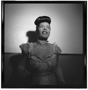 Black-and-white photograph of Billie Holiday in Carnegie Hall, New York City, taken by William P. Gottlieb between 1946 and 1948.