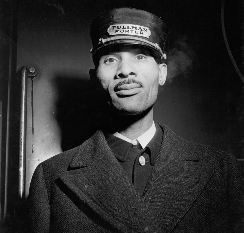 Black-and-white photograph of a Black sleeping-car porter employed by the Pullman Company at Union Station in Chicago, Illinois, 1942