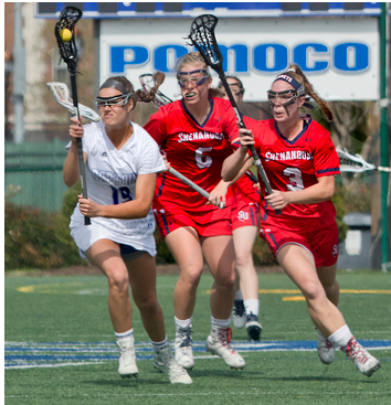 Photograph of several members of the women's lacrosse teams from Christopher Newport University and Virginia Shenandoah University during a match in 2017. 