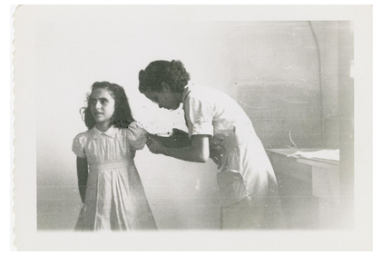 Black-and-white photograph of a female nurse immunizing a young girl, taken in the 1930s in Mississippi.