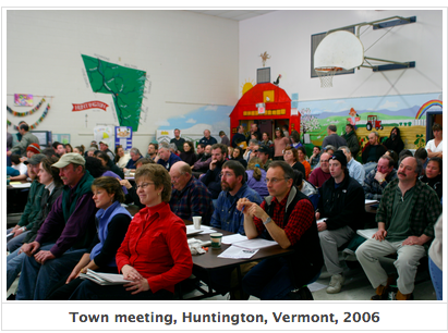 Photograph of a town meeting taking place in a school auditorium in Huntington, Vermont, taken in 2006.