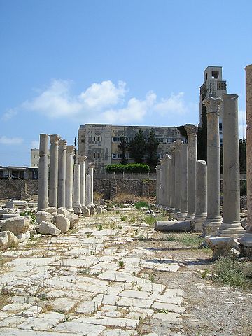 Photograph of ancient ruins, showing a rocky floor and pillars in a large open space.
