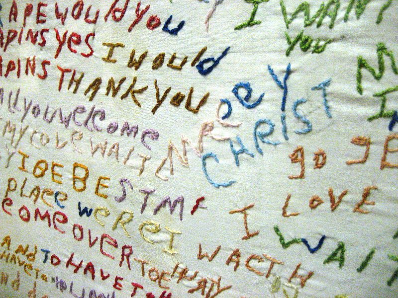 Word salad of various words embroidered on a cloth.