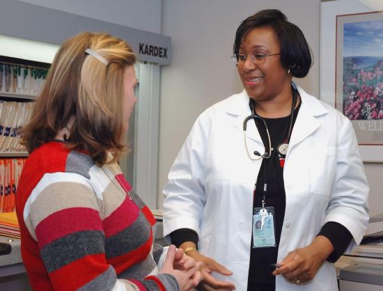 A healthcare professional speaking with a patient