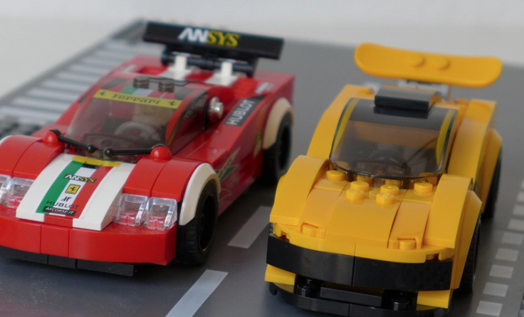 Two toy cars side by side, one red and one yellow