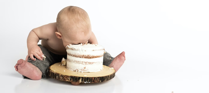 Infant eating a cake.