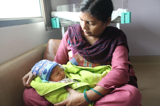 Caregiver holding a sleeping infant.