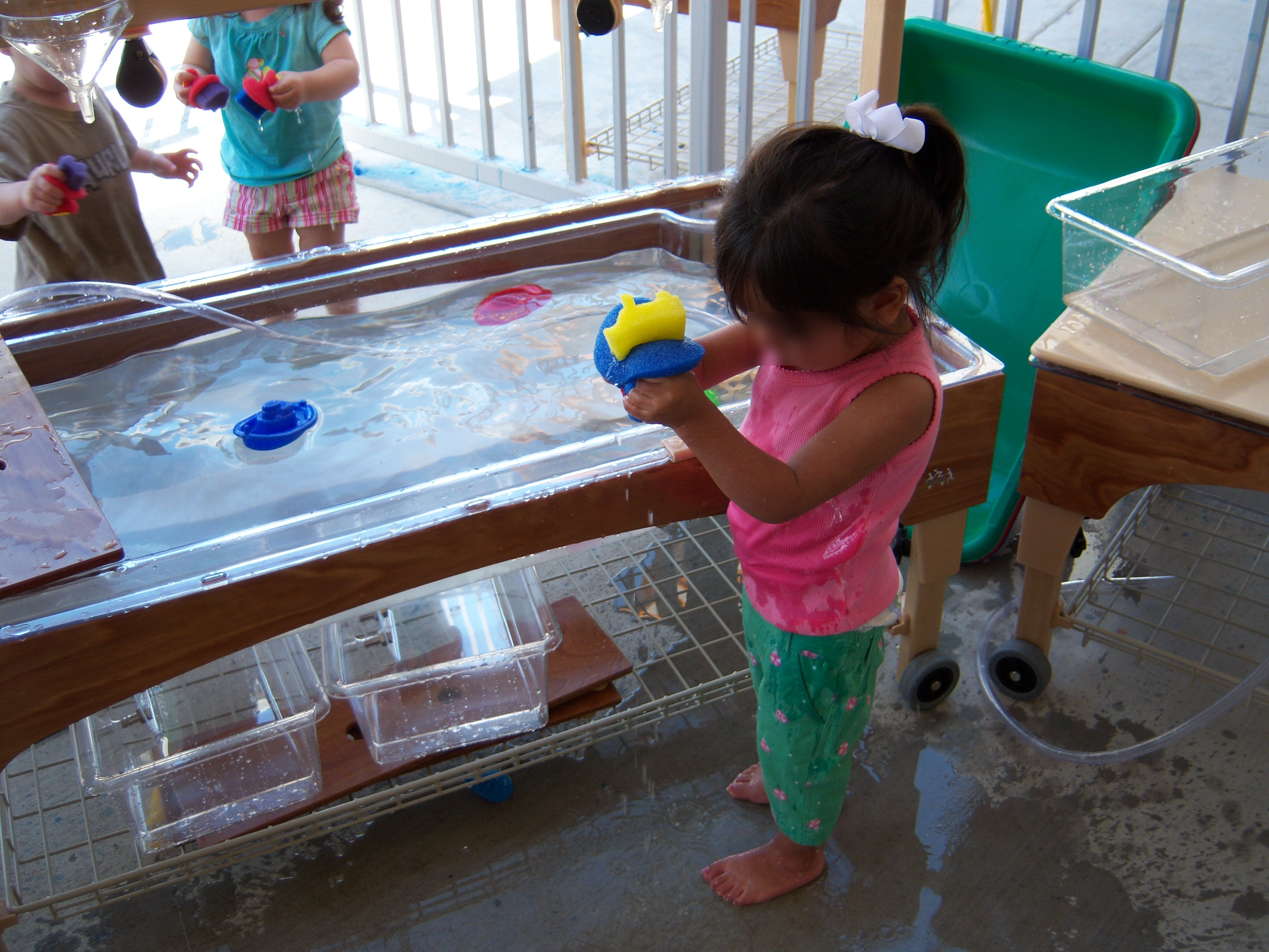 Toddlers at water table.