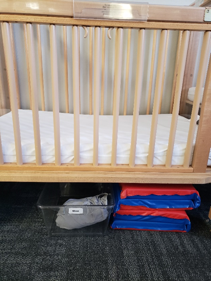 Second set of sheets labeled with child's name under shared crib. 