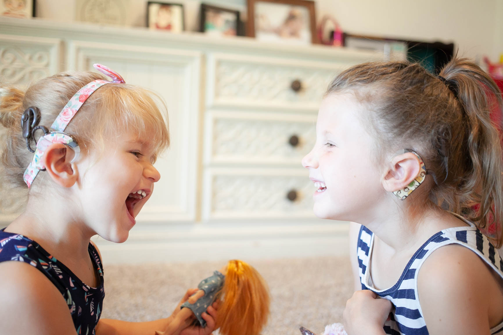 A toddler and preschooler with cochlear implants.
