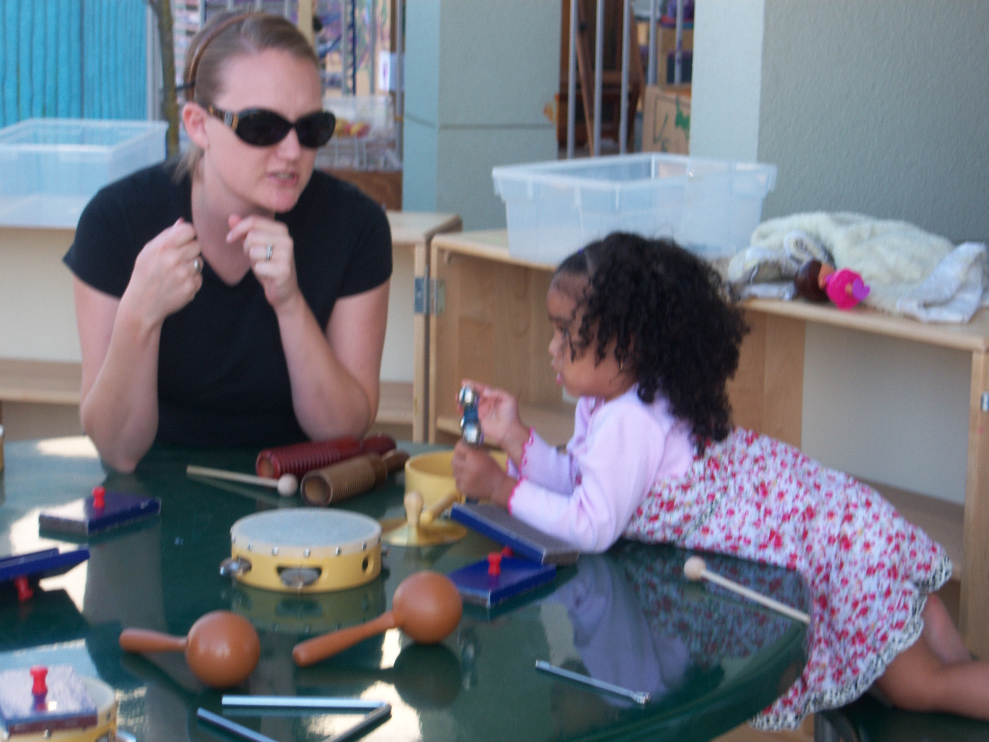 Caregiver and toddler talking at a table