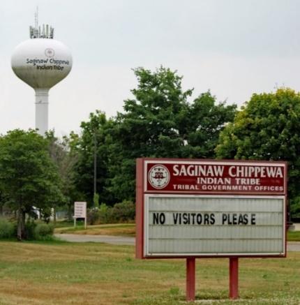 A sign in front of a water tower

Description automatically generated with medium confidence