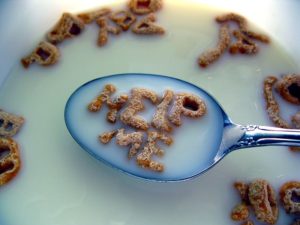 bowl of alphabet cereal with letters forming the words "help me"