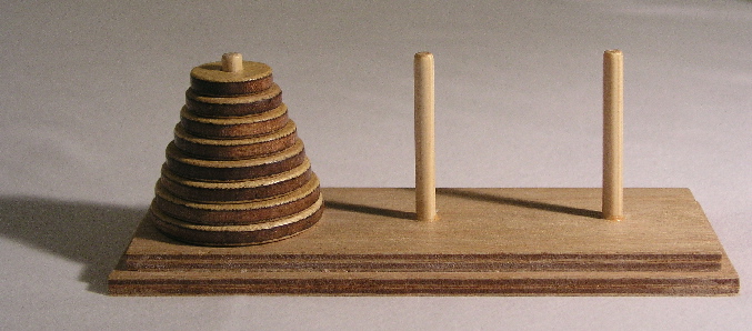 Tower of Hanoi problem which starts with a stack of wooden circles of increasing size and three posts where they can be moved.